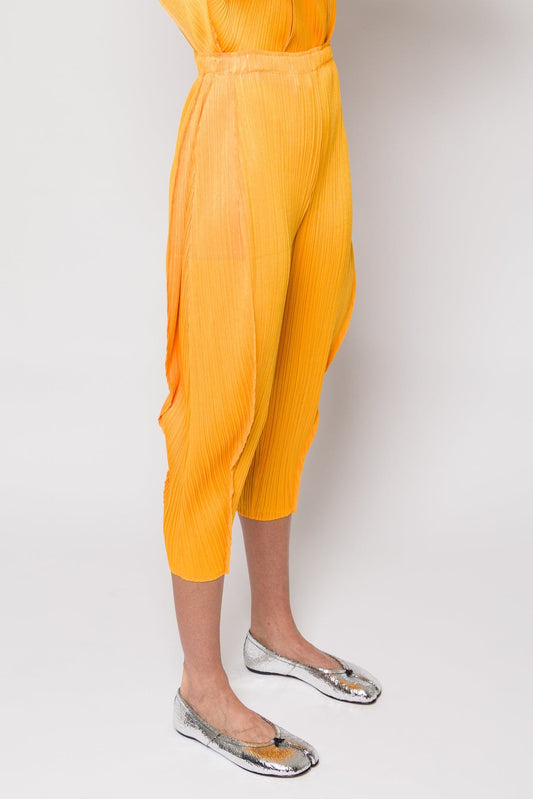 Pleats Please Issey Miyake Lantern Trousers in Orange Yellow SS25 side