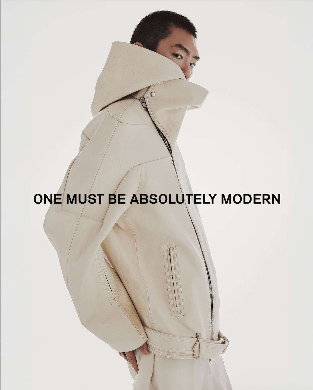 Brandon in Look 3 of SS25 menswear editorial wearing Rick Owens in layered parchment and dinge — clean lines meet raw finish. Explore and shop our selection of Rick Owens pieces now at our Atlanta luxury boutique.