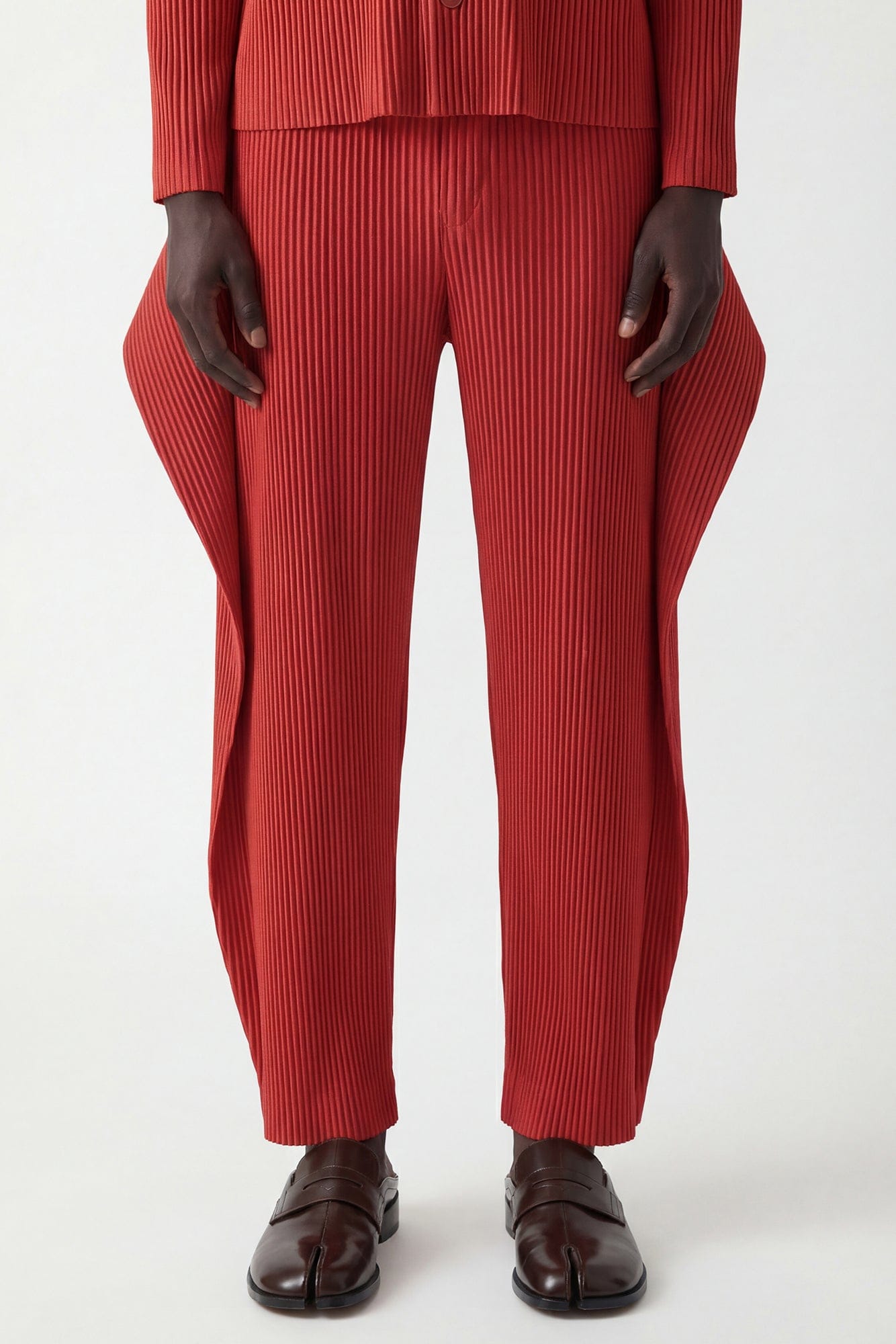 Homme Plissé Issey Miyake Cover and Fold Trousers in Tomato Red