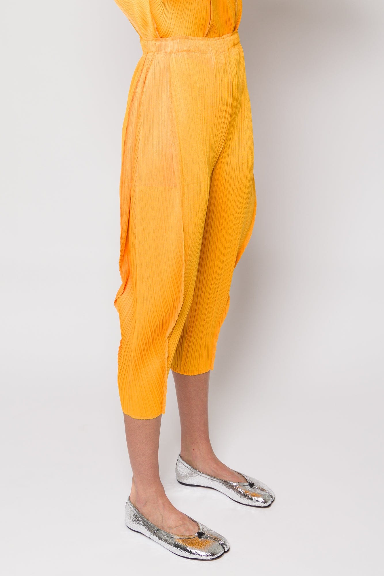 Pleats Please Issey Miyake Lantern Trousers in Orange Yellow SS25 side